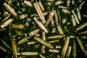 many empty bullet shells, pile of used rifle cartridges 7.62 mm caliber, assault rifle bullet...