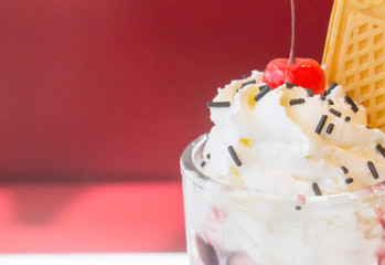Whipped cream ice in cup with strawberry