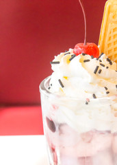 Whipped cream ice in cup with strawberry
