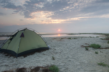 Tourist tent on the sandy seashore.