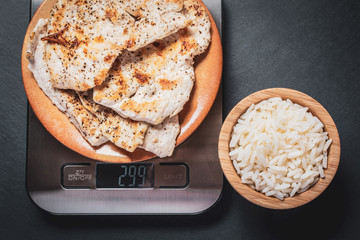 kitchen scale, grilled chicken breast and cooked rice, healthy food