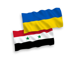 Obraz premium National vector fabric wave flags of Syria and Ukraine isolated on white background. 1 to 2 proportion.