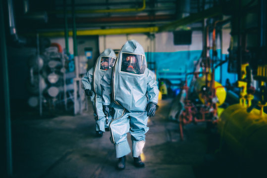 Rescuers in a radiation protection suit.