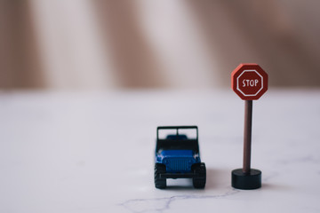 miniature of a car in front of a road sign