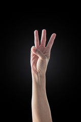 Hand up with 3 three fingers with rim light isolated on black background (clipping path)
