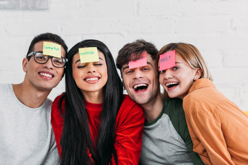 multicultural friends with funny nickname labels on foreheads