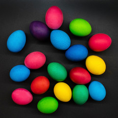 Variety of painted Easter eggs on dark background