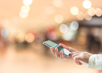 Digital lifestyle business person or shopper using mobile smart phone for retail shopping in mall...