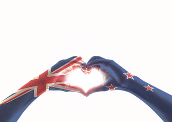 New Zealand flag on people heart shaped hands isolated on white background (clipping path) for NZ...