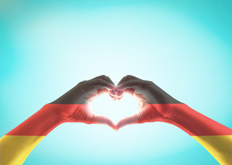 Germany national flag on people heart shape hands.