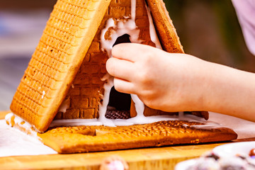 Familiy building a sweet ginger bread house
