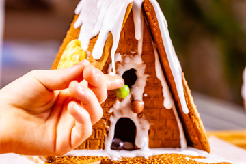 Familiy building a sweet ginger bread house