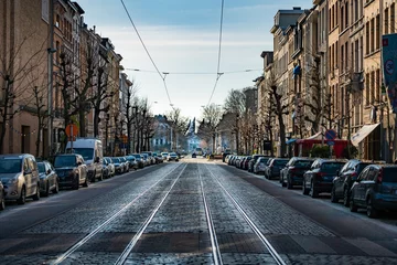 Fotobehang empty street full of parked cars © Twan van Asseldonk