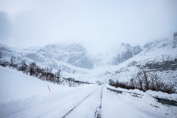  snow-covered road and mountains, Lofoten Islands, Norway