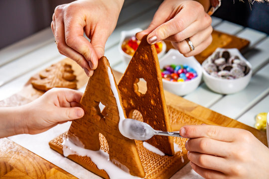 Familiy Building A Sweet Ginger Bread House