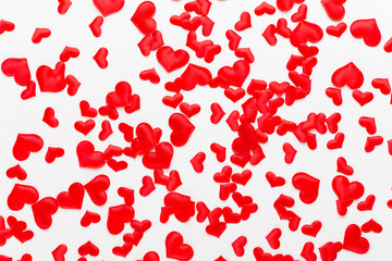 Valentines day background red hearts on white wooden background.