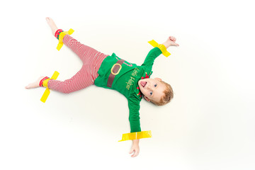 Beautiful little boy dressed like Christmas elf with big smile. Christmas concept. Studio portrait over green background