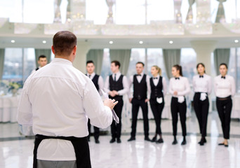 Briefing at the restaurant. The Chef is briefing the restaurant.. interacting to head chef in...