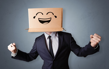 Funny man wearing cardboard box on his head with smiley face
