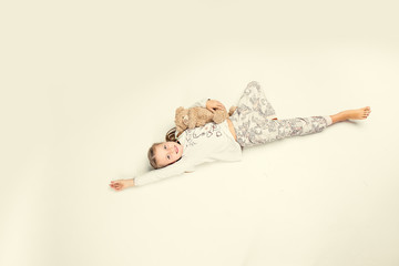 children in winter pajamas hugging each other © Mariia
