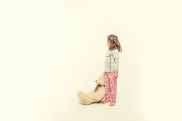 children in winter pajamas hugging each other © Mariia