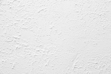 White textured wall. Decorative plastering close-up photo. Surface with stucco daub