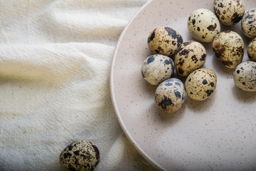 variegated quail eggs on a flat plate