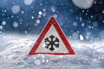 winter driving - risk of snow and ice - traffic sign