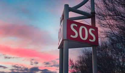 SOS signal text outdoor on sky background