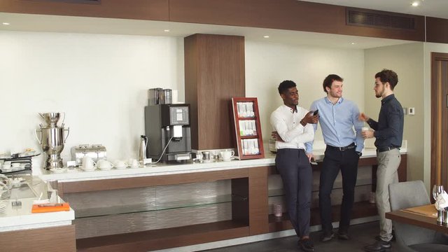 Handsome guys discussing some problems at work, spare time at workplace.friendship, partnership.