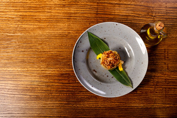 dish of  Ratotoue with leaf on back wood background 