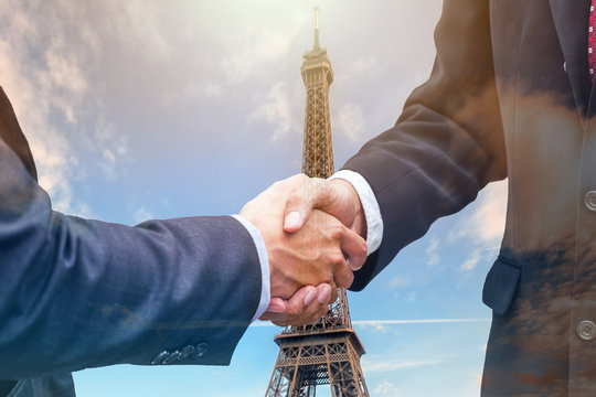 Handshake agreement of businessman with partnership on eiffel tower
