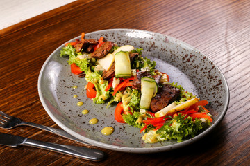 salad with meat decorated on wood background 