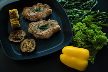 Grilled striploin steak with spices and herbs on grill iron pan.The strip steak, also called a New York strip.