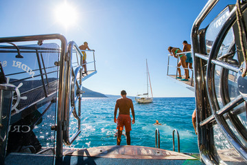 Athletic man on a yacht on a beach in Greece