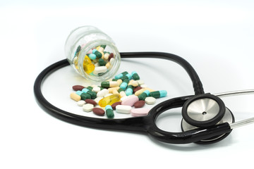 A black stethoscope around assorted medication and glass bottle