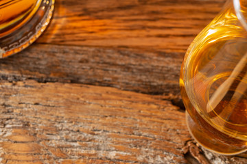 Irish Whiskey Glass and Whiskey Bottle on Reclamined Wood Soft Focus