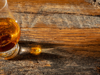 Irish Whiskey Glass on Wooden Table in Sunlight