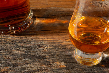 Irish Whiskey Glass and Whiskey Bottle on Reclamined wood in sunshine