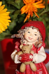 German girl toy in red hat with bear