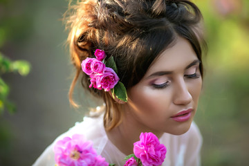 Naklejka premium Portrait of a girl with make-up. With flowers in her hair. Beautiful face.