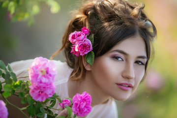 Naklejka premium Portrait of a girl with make-up. With flowers in her hair. Beautiful face.