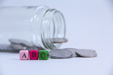  A,B and C in wooden block with coin at the back