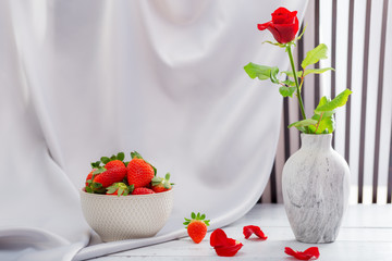 Red rose, strawberries and champagne for the celebration of women's holidays and anniversaries.