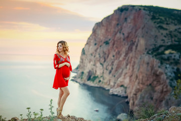 female travel nature scenery landscape concept of lady in red dress stay on edge of mountain top above south sea in summer bright weather with little wind on cape