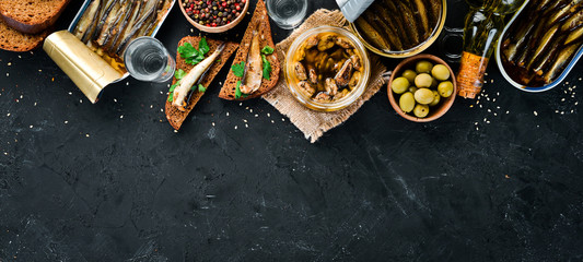 Sandwich with Sprat. Sprat in oil. On a black background. top view. Free copy space.