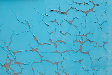 Blue wall texture with cracked old paint