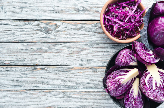 Red cabbage. Purple cabbage on a white wooden background. Organic food. Top view. Free space for your text.