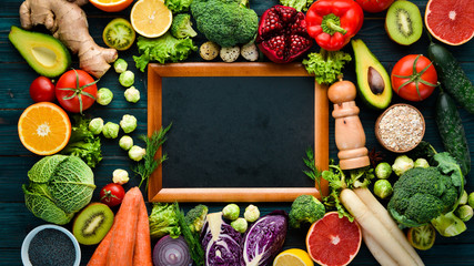 Healthy organic food on a blue wooden background. Vegetables and fruits. Top view. Free copy space.
