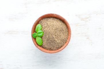 Black ground pepper. Spices Top view. On the old background.